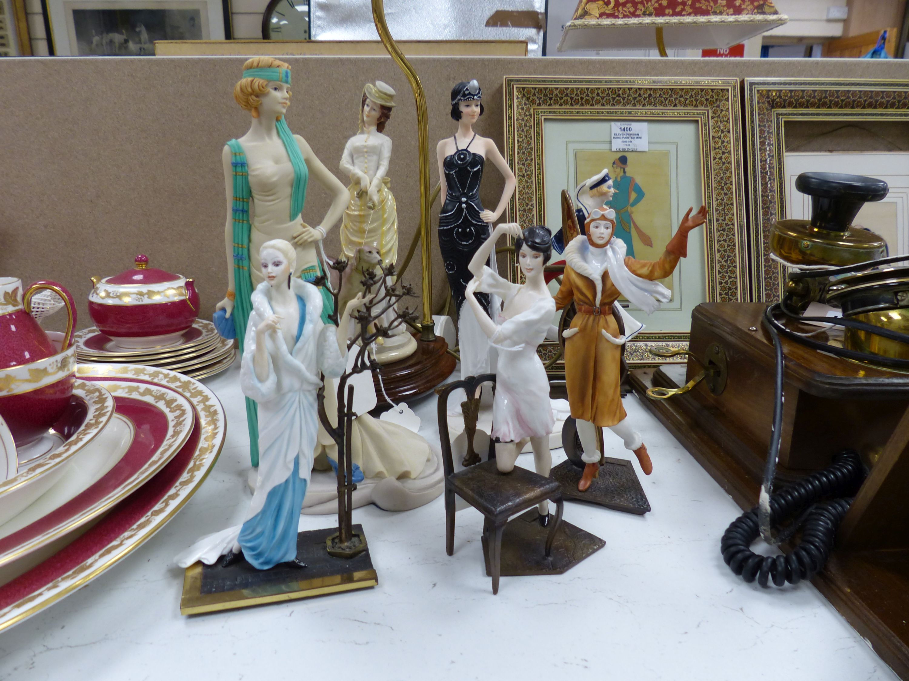 Four Albany bronzed metal and ceramic of elegant 1920's ladies, including 'Female Aviator', three other figures and a table lamp (8)